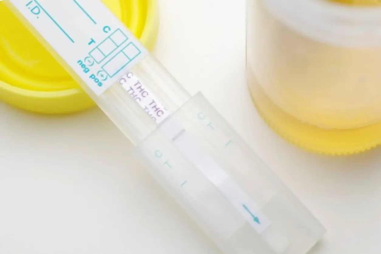 Close-up of a pregnancy test showing positive result on a white surface.